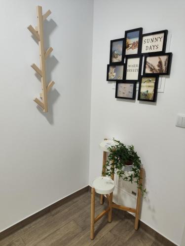 a table and a stool in a room with a wall at Casa Aqueduto in Lisbon