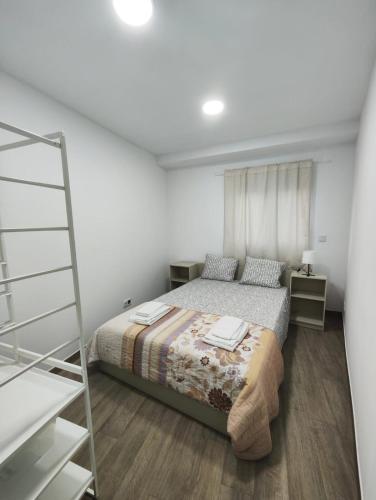een kleine slaapkamer met een bed en een ladder bij Casa Aqueduto in Lissabon