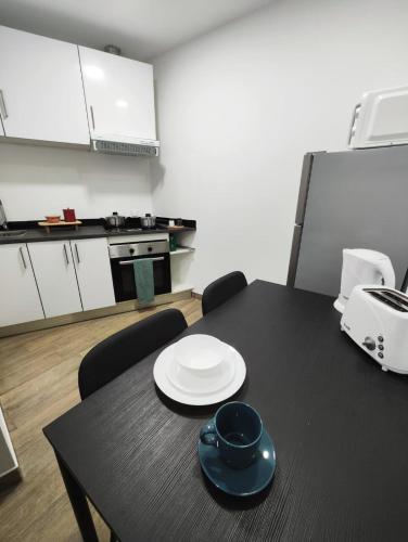 a black table with a plate on it in a kitchen at Casa Aqueduto in Lisbon