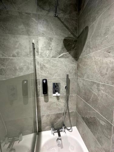 a bathroom with a sink and a shower stall at Gainsborough Lodge in Horley