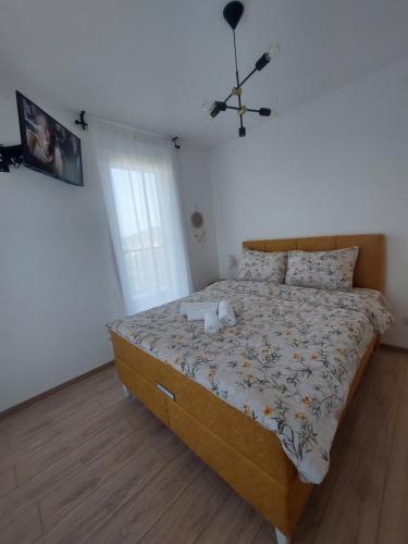a bedroom with a large bed in a room at Apartman Andrea2 in Vrnjci