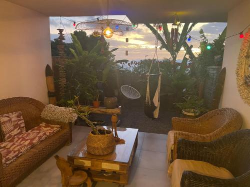 a living room with two couches and a table at Ti kaz coco in Saint-Leu