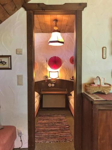 a hallway with a room with a table and a lamp at Almapartment in Sonnleitn am Nassfeld auf 1484m in Hermagor