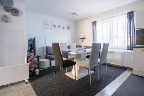 a kitchen and dining room with a table and chairs at Apartma Ella in Lovrenc na Pohorju