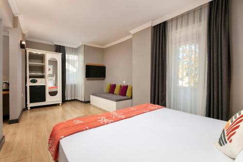 a bedroom with a large white bed and a window at Azuu Boutique Hotel in Antalya