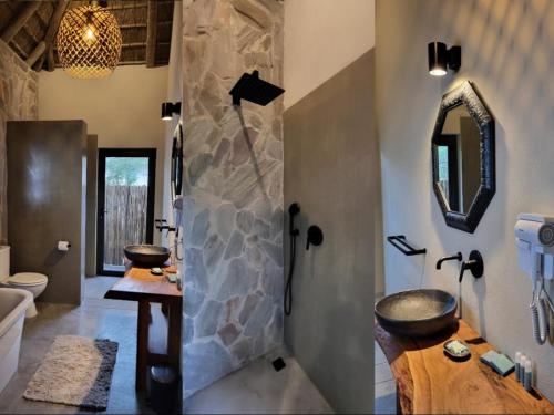 een badkamer met een stenen douche en een wastafel bij Taaibos Bush Lodge in Hoedspruit