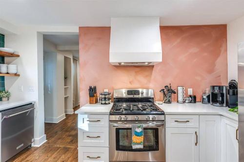 a kitchen with white cabinets and a stove top oven at The Wingate Nashville Hot Tub & Airstream Oasis in Nashville