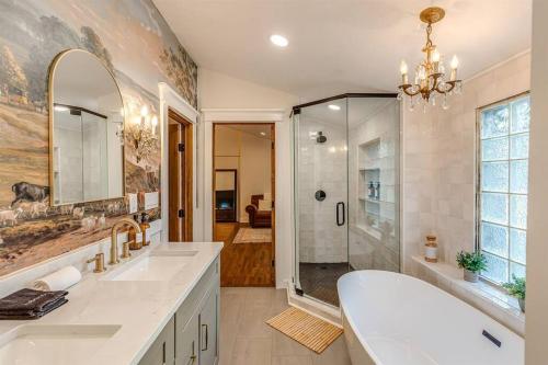 a bathroom with a shower and a sink and a tub at The Wingate Nashville Hot Tub & Airstream Oasis in Nashville