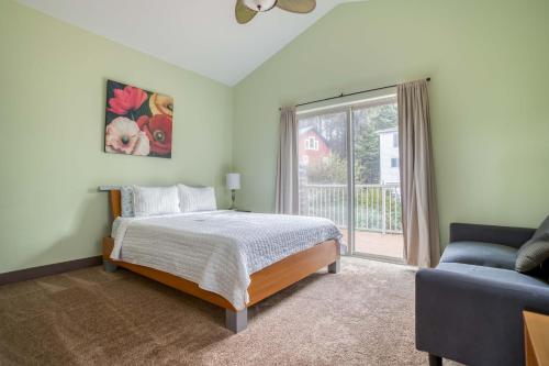 a bedroom with a bed and a window and a couch at Coastal Dream in Lincoln City