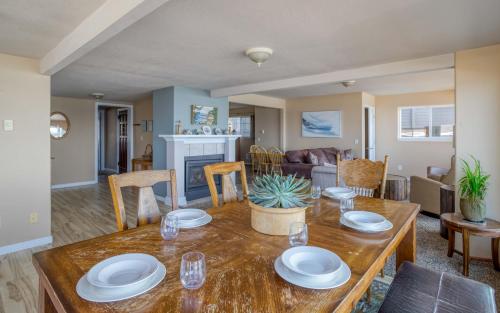 a dining room and living room with a wooden table at Anchors Aweigh in Lincoln City