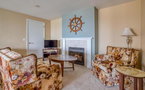 a living room with two chairs and a fireplace at Anchors Aweigh in Lincoln City