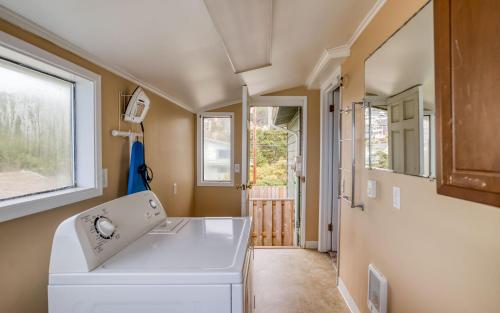 a kitchen with a white sink and a window at Anchors Aweigh in Lincoln City