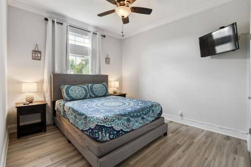 a bedroom with a bed and a ceiling fan at Old Town Bay St. Louis Outdoor Bar Area Game Room in Bay Saint Louis