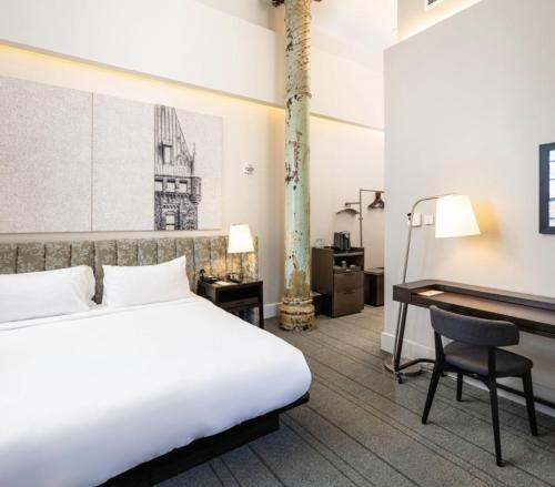a hotel room with a bed and a desk at The Richardson Hotel in Buffalo