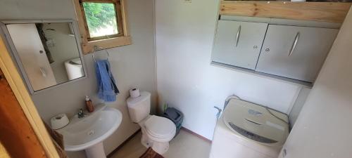 uma pequena casa de banho com WC e lavatório em Pieza y estacionamiento independiente em Panguipulli