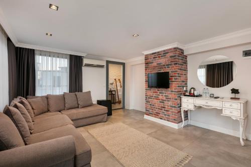 a living room with a couch and a brick fireplace at Azuu Boutique Hotel in Antalya