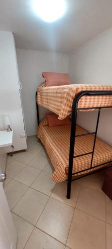 two bunk beds in a small room with a light at casa villa costa de sol, calderilla in Calderilla