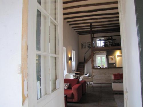 a view of a living room with a red couch at Hotel Plaza Malloa in Malloa
