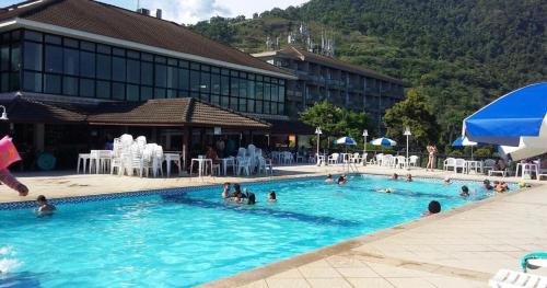 a group of people in the swimming pool at a hotel at Vista serra, praia e mar in Mangaratiba