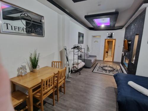 a living room with a table and a couch at 31 London Road Liverpool Studio Sleeps 4 in Liverpool