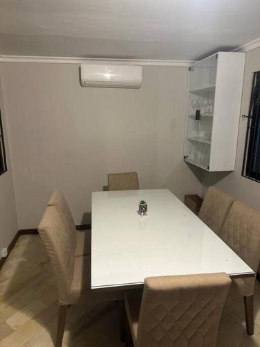 a white table and chairs in a room at Melhor localização de Floripa. in Florianópolis