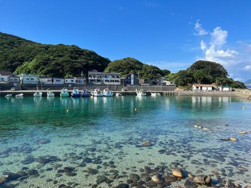 a view of a body of water with boats in it at ゲストハウスみんちゅう in Sukumo