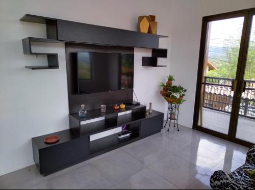 a living room with a flat screen tv on a wall at Casa ALGABELLA in Ángeles