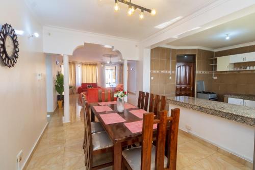 a dining room and kitchen with a table and chairs at 3 bedroom Nyali apartment in Mombasa