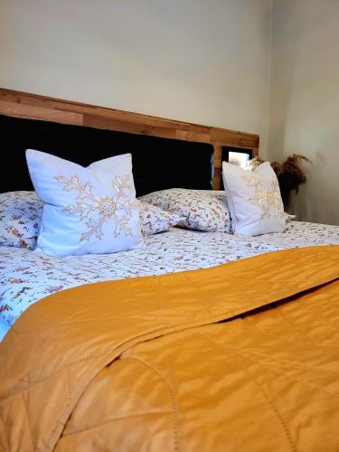a bed with two pillows on top of it at HAFCIK Apartamenty in Poronin