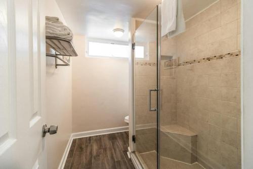 a shower with a glass door in a bathroom at King Bed Ocean View 2nd Floor in Pawleys Island