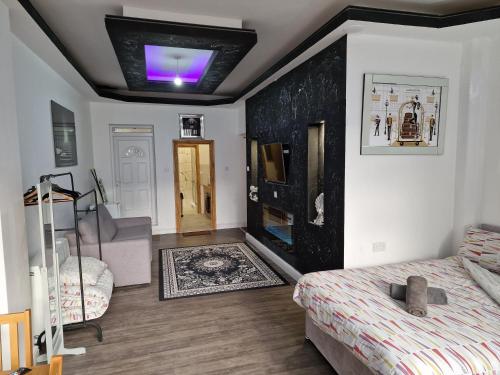 a bedroom with a bed and a ceiling with a purple light at 31 London Road Liverpool Studio Sleeps 4 in Liverpool