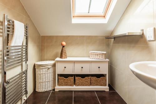 a bathroom with a sink and a white cabinet at Garden Cottage, Crail in Crail