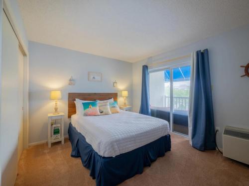 a bedroom with a bed and a large window at Wesley Paradise Chic1BD Private Balcony and Pool in Ocean City