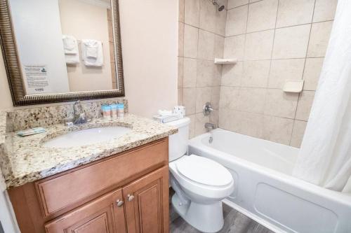 a bathroom with a sink and a toilet and a bath tub at 3rd Floor Close to Beach Sleeps 4 in Pawleys Island