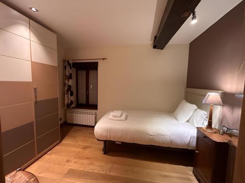 a small bedroom with a bed and a window at Apto ElizaG-1 in Lesaka