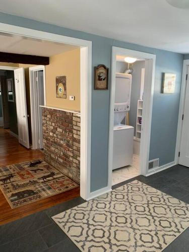 a living room with blue walls and a brick fireplace at The Cottage in East Poultney in Poultney