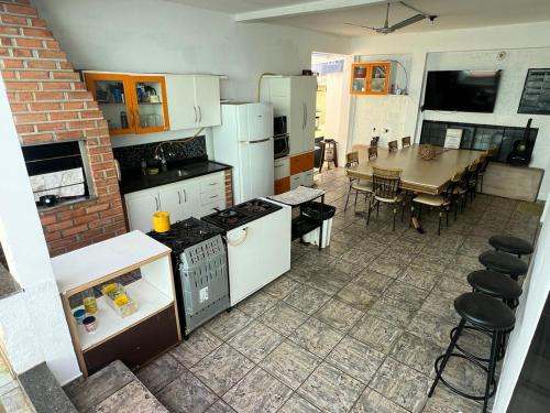 a kitchen and dining room with a table and a dining room at Hostel Sideral in Campo Grande