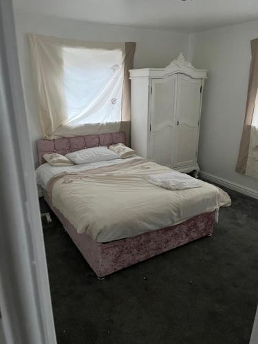 a bedroom with a bed and a dresser at High Street Lodge in Clowne