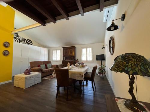 a living room with a table and a couch at Casa di Adelaide in Schio