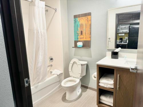 a bathroom with a toilet and a sink at Fort Stockton Inn and Suites in Fort Stockton