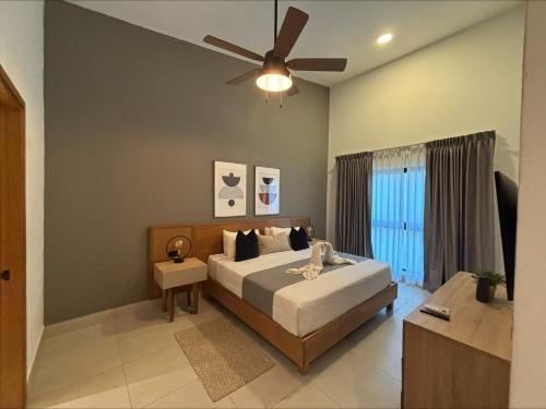 a bedroom with a bed and a ceiling fan at Penthouse Paradise with Jacuzzi in Cap Cana in Punta Cana