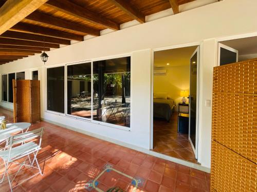a living room with large windows and a patio at Private Room Playa Negra in Playa Negra