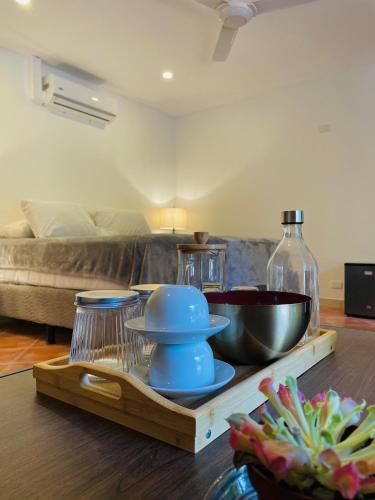 a living room with a table with a bowl on a tray at Spinoza Hotel Los Pargos Playa Negra in Playa Negra