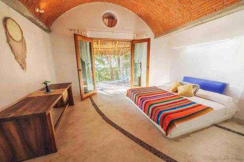 a bedroom with a bed with a rope around it at Casa Guadalupe, Oceanview Tranquility, Heated Pool in Aticama