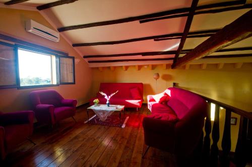 a living room with red couches and a table at La Mimosa Case Vacanze in Marsala