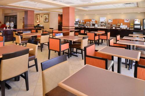 a dining room with tables and chairs in a restaurant at Holiday Inn Express & Suites Austin North Central by IHG in Austin