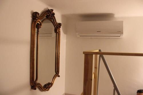 a mirror on a wall next to a air conditioner at 4 posti letto vicino pala alpitour! in Turin