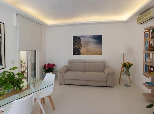 a living room with a couch and a table at YourHome in Vico in Vico Equense