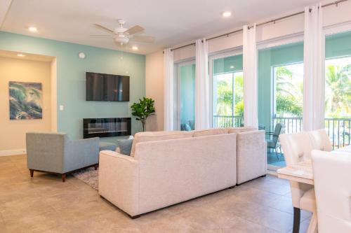 a living room with a couch and chairs and windows at One Particular Harbour 379-101 in Bradenton