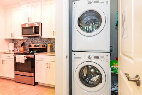 a kitchen with a washing machine and a washer and dryer at One Particular Harbour 379-101 in Bradenton